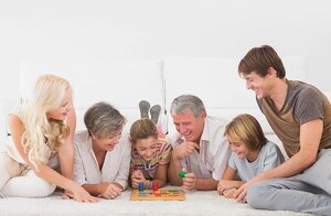 Family playing board games in sitting room