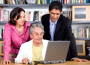 older adult with family and lawyer using computer at home