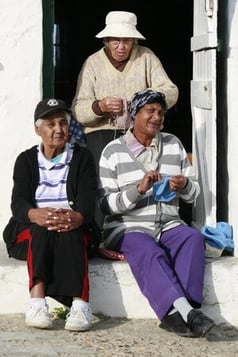 group of people knitting outside
