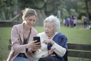 cheerful-senior-mother-and-adult-daughter-using-smartphone-3791664_1_1_1