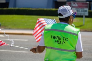 man wearing vest volunteering at parade