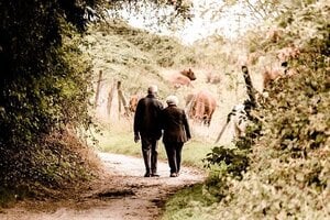 senior couple walking on path outdoors