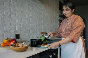 older woman cooking at home in kitchen