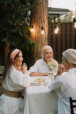 older women enjoying a meal together outside