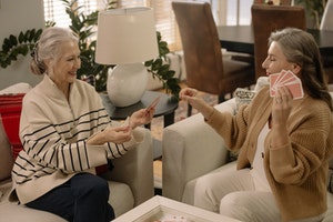 two older women playing cards together