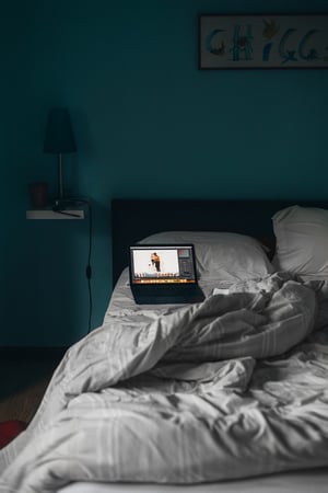 laptop on unmade bed