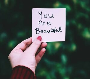You are beautiful affirmation written on sticky post-it note