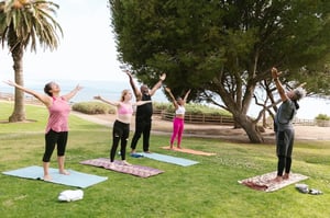 seniors practicing yoga outdoors