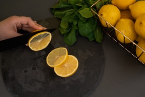 person slicing lemons on counter