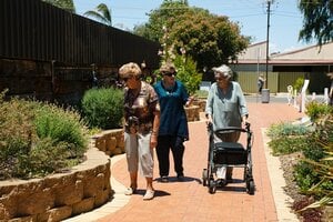 older women wearing sunglasses walking together outdoors