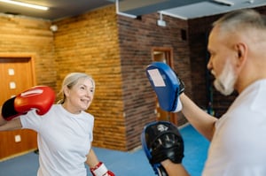older couple practicing boxing together 
