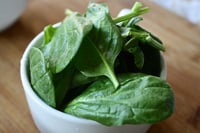 spinach leaves in a white bowl
