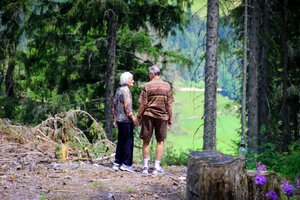 older couple going for a walk hike in the woods