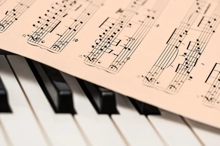 sheet music sitting on piano keys